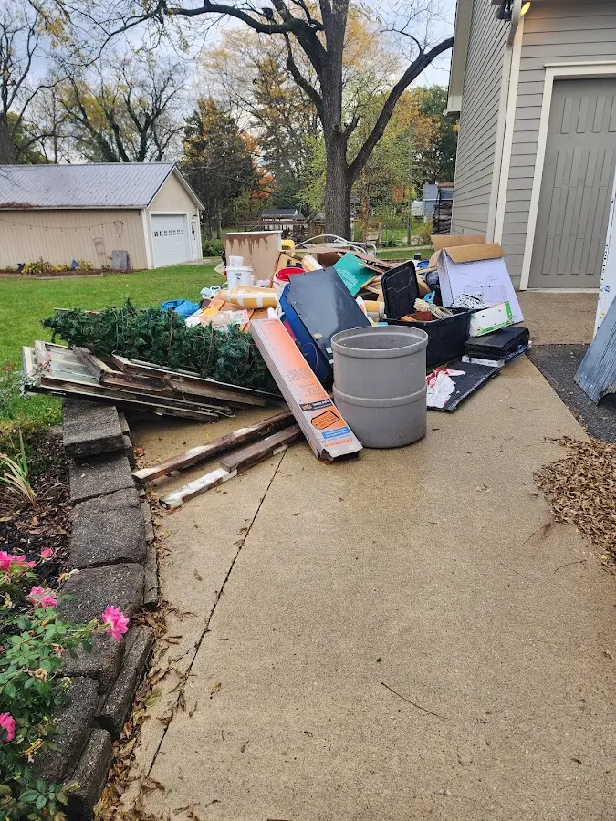 Dumpster being loaded with debris for 12 Yard Dumpster Rental in Fort Mitchell